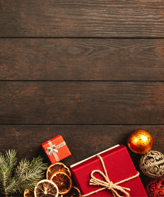 presents and ornaments on dark wood background