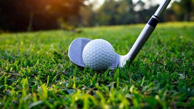 a golf club putting a golf ball