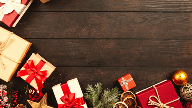 presents and ornaments on dark wood background
