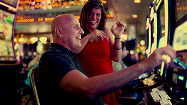 older couple at a slot machine
